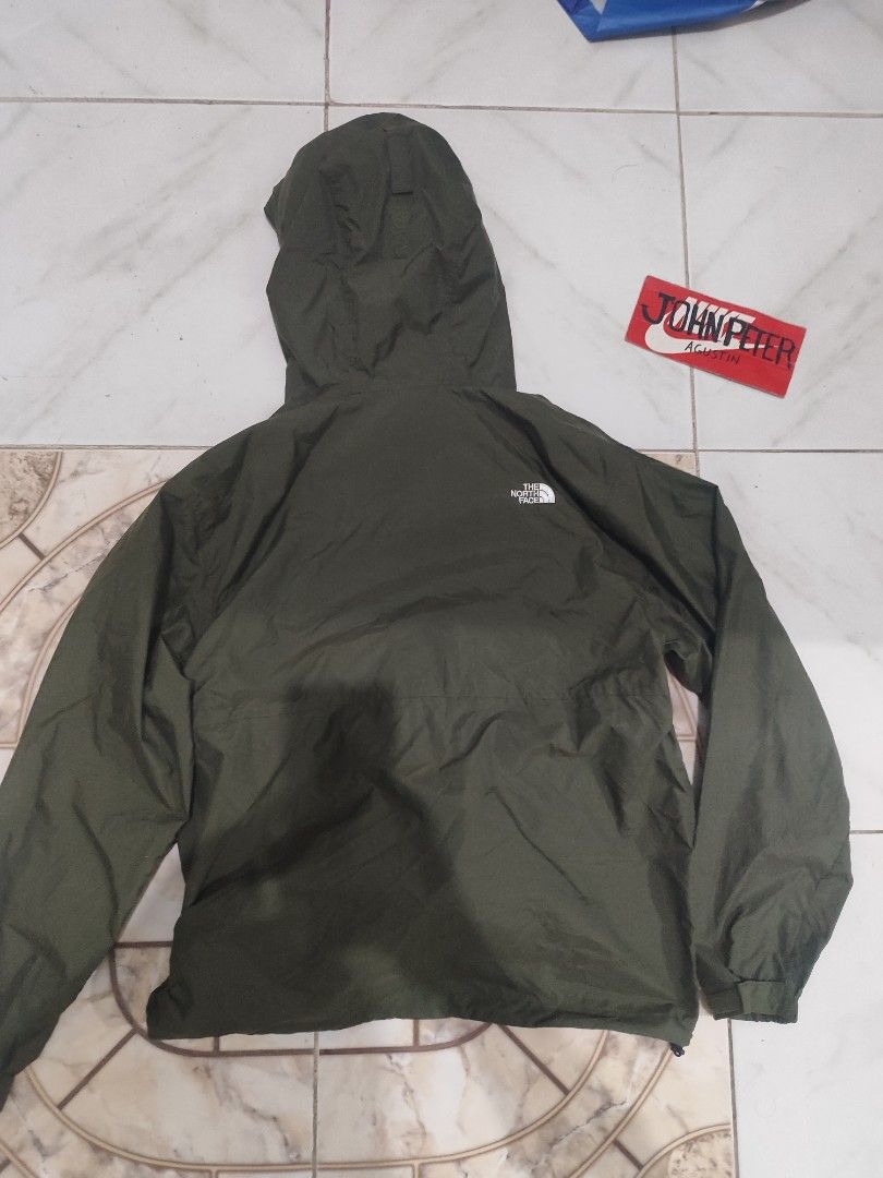 The North Face packable Windbreaker water repellent Jacket (Category: Coats, Jackets and Outerwear) located in Tuguegarao City. Submitted by johnpetera0818 (Listing ID 1470320260, Image 2). Description: - Brand: The North Face (Goldwin Inc.) - Model: NP72230 - Color: Green with Green Cycle eco-label - Material: 100% Nylon - Features: Attached hood with drawcords, full zip closure, and two zippered hand pockets - Bonus: Includes small white stuff 