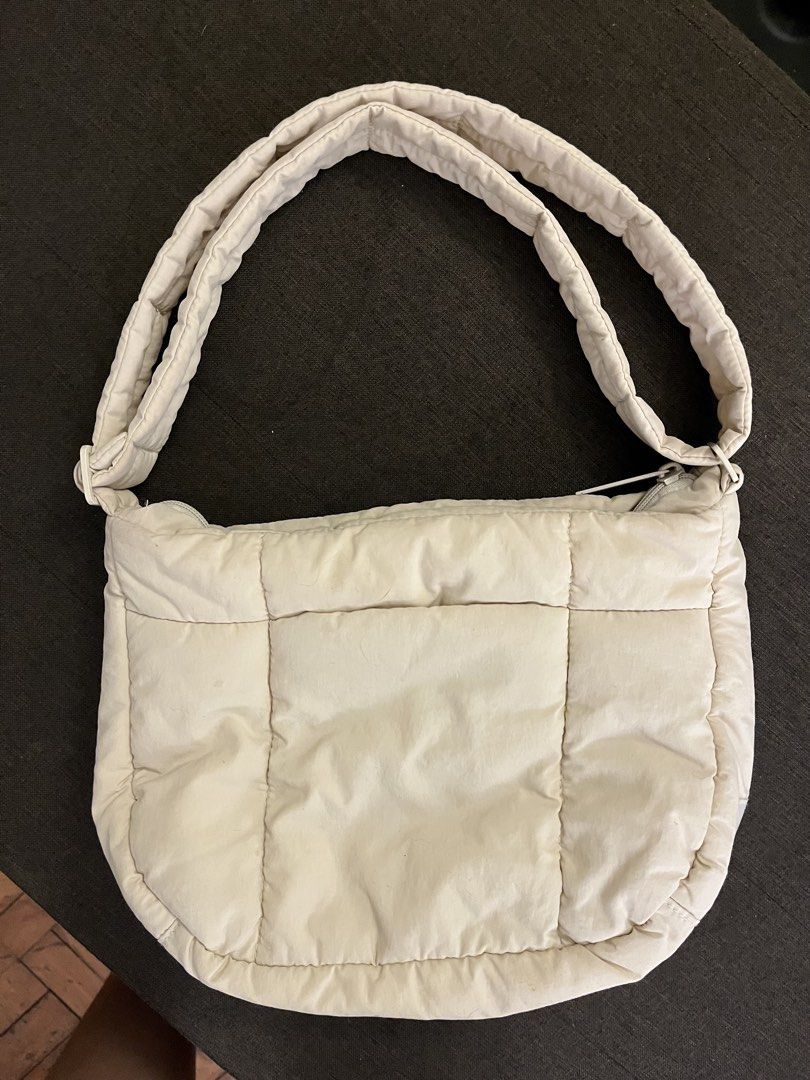 The Paper Bunny Puffer Bag Aspen (Category: Tote Bags) located in Quezon City. Submitted by live_louisee (Listing ID 1470313955, Image 2). Description: - Authentic The Paper Bunny puffer shoulder bag in cream / off-white - Material: Soft and puffy quilted nylon - Closure: Secure zippered main compartment - Pockets: Convenient front pocket for small essentials - Straps: Thick strap designed for comfortable shoulder wear - Details: Subtle embroider