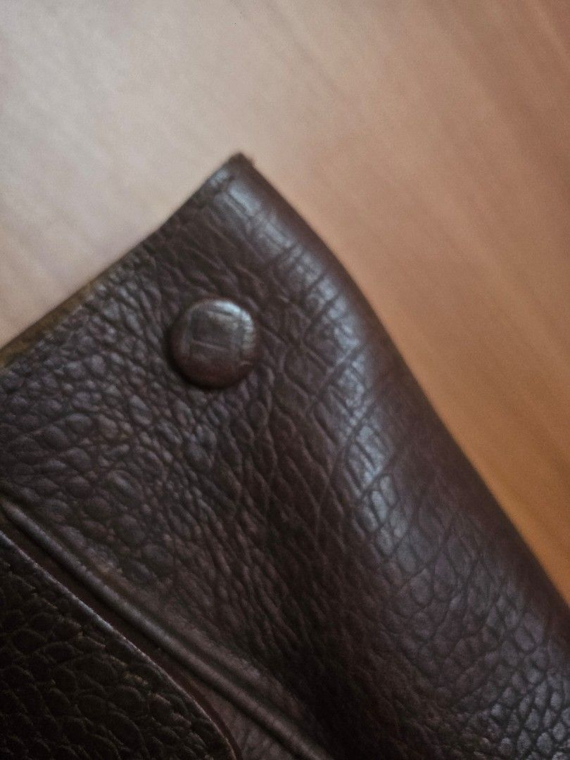 The Tannery Manila Leather Handbag (Category: Shoulder Bags) located in Mandaluyong City. Submitted by ohwmaria (Listing ID 1470227919, Image 2). Description: - Material: Brown embossed leather with reptile-pattern texture - Closure: Secure flap closure with dark metal hardware - Pockets: Multiple exterior and interior zip pockets for easy organization - Interior: Suede lining with branded leather patch label - Design: Structured top handles and 