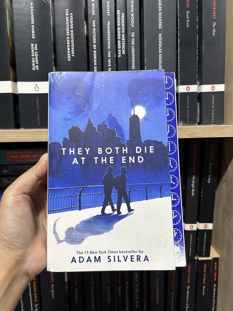 They Both Die at the End by Adam Silvera (Category: Storybooks) located in Manila. Submitted by meannt. (Listing ID 1470225864, Image 1). Description: - Title: They Both Die at the End - Author: Adam Silvera - Format: Paperback - Bestseller: #1 New York Times Bestseller - Genre: Young Adult (YA) Contemporary Fiction - Cover: Blue illustrated city skyline design - Condition: Great / Well-maintained.