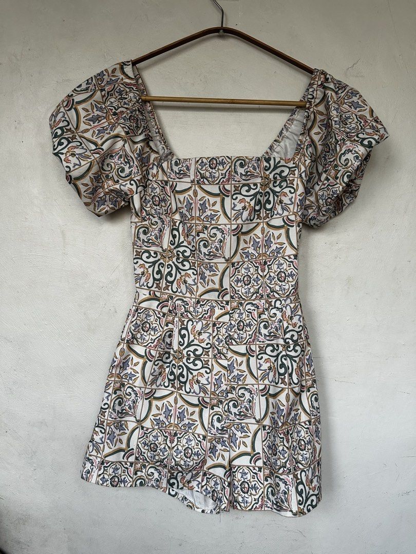 Tile Print Puff Sleeve Square Neck Romper (Category: Rompers) located in Manila. Submitted by omelette.12 (Listing ID 1470246295, Image 1). Description: - Style: Short one-piece romper with pleated shorts - Design: White base with vibrant multi-color Mediterranean tile pattern - Details: Chic square neckline, trendy puff sleeves, and a flattering fitted waist - Perfect for: Warm weather, sunny days out, or weekend brunch - Fit: Easy to slip on an
