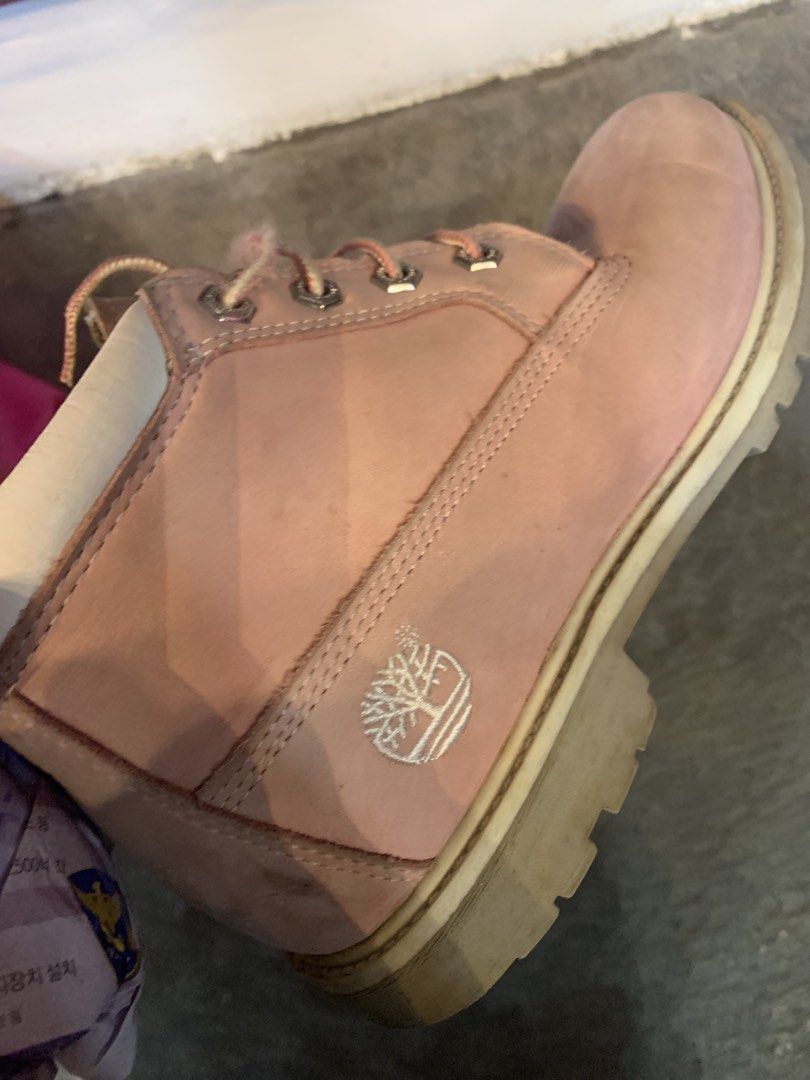 Timberland Pink Waterproof Boots (Category: Boots) located in Pasig City. Submitted by cool.itshara (Listing ID 1470233586, Image 2). Description: Pink Timberland waterproof boots with white collars and laces. Classic rugged style, chunky rubber outsoles. Size US 6.5. Shows normal wear on soles and uppers from previous use. Sturdy construction, ready for more outdoor adventures..
