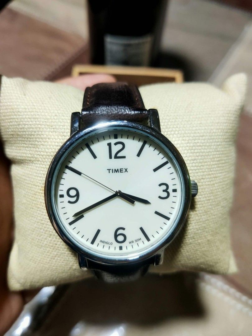 Timex Indiglo Watch with Dark Brown Leather Strap (Category: Men's Watches) located in Manila. Submitted by jhs31 (Listing ID 1470307314, Image 3). Description: - Brand: Timex - Dial: Off-white with bold black numbers and signature Indiglo night-light - Strap: Dark brown genuine leather with stylish contrast stitching and silver-tone buckle - Water Resistance: Up to 30 meters - Inclusions: Original black Timex display box, watch cushion, and hang