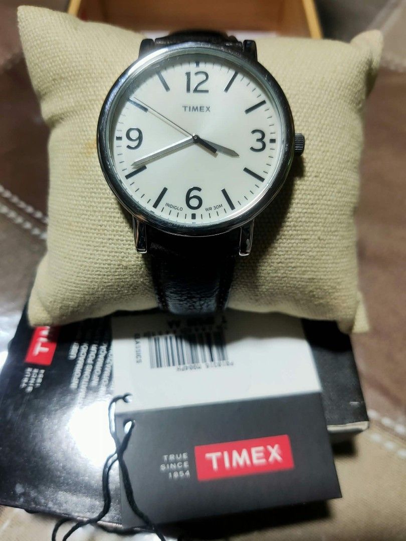 Timex Indiglo Watch with Dark Brown Leather Strap (Category: Men's Watches) located in Manila. Submitted by jhs31 (Listing ID 1470307314, Image 2). Description: - Brand: Timex - Dial: Off-white with bold black numbers and signature Indiglo night-light - Strap: Dark brown genuine leather with stylish contrast stitching and silver-tone buckle - Water Resistance: Up to 30 meters - Inclusions: Original black Timex display box, watch cushion, and hang