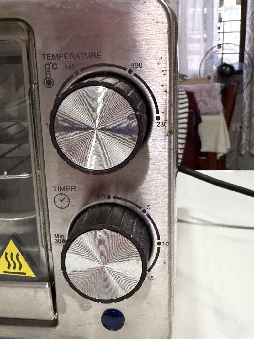 Toaster oven, american home (Category: Ovens & Toasters) located in Malolos. Submitted by jaizemndz22 (Listing ID 1470276391, Image 3). Description: - Durable stainless steel countertop toaster oven - Dual control knobs: temperature up to 230°C and 30-minute timer - Clean interior with minor signs of use on the tray and knobs - Side ventilation for safe airflow - Standard power plug attached .