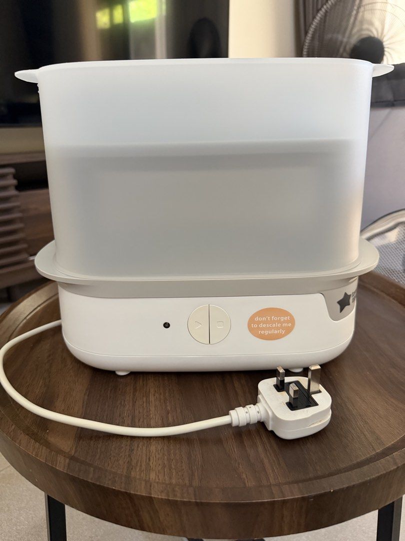 Tommee Tippee Electric Bottle Steriliser (Category: Breastfeeding & Bottle Feeding) located in Taguig. Submitted by enabee (Listing ID 1470213338, Image 1). Description: - Brand: Tommee Tippee Electric Steam Steriliser - Condition: Clean and well-maintained heating plate - Includes: Base unit, transparent cover, two-tier rack, and tongs - Features: Simple one-button operation, side reminder sticker, and bottom cable wrap - Plug type: Standard UK 