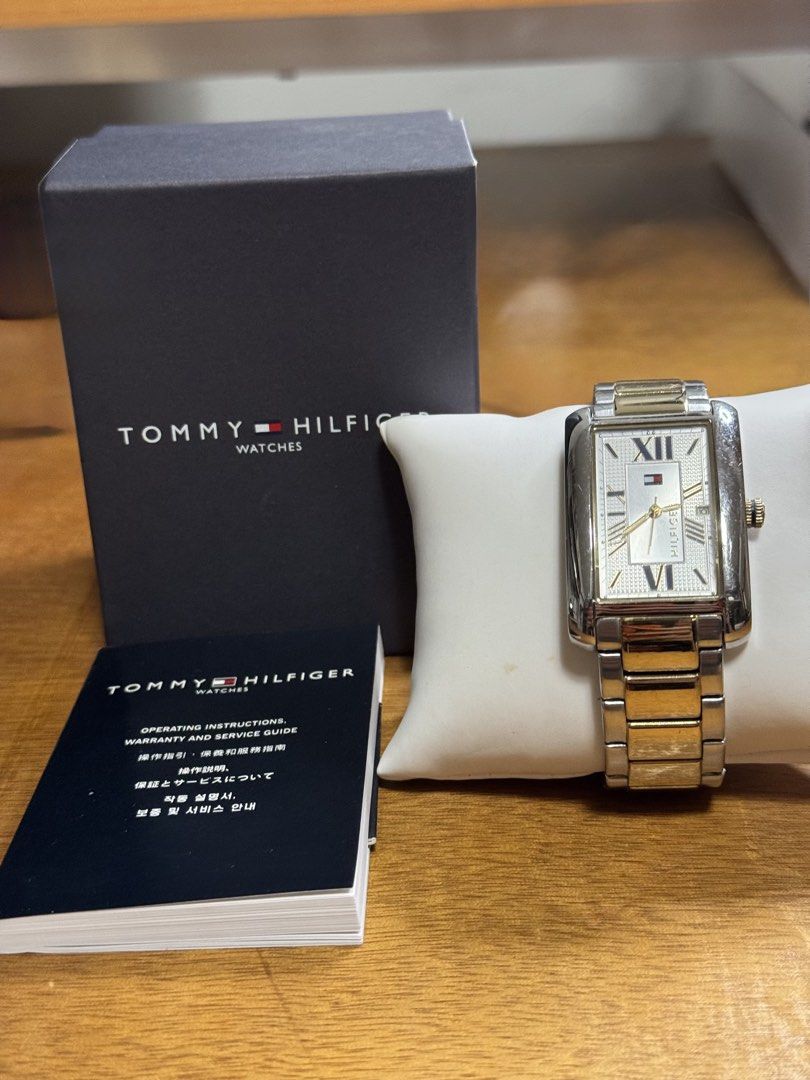 Tommy Hilfiger Rectangular Two-Tone Watch with Box and Manual (Category: Women's Watches) located in Valenzuela. Submitted by wisetree_18aeb6 (Listing ID 1470206872, Image 1). Description: - Brand: Tommy Hilfiger - Design: Rectangular case with a textured white dial, Roman numerals, and date display - Strap: Two-tone silver and gold metal bracelet with a deployment clasp - Details: Gold crown, elegant and classic everyday wear - Inclusions: Origi