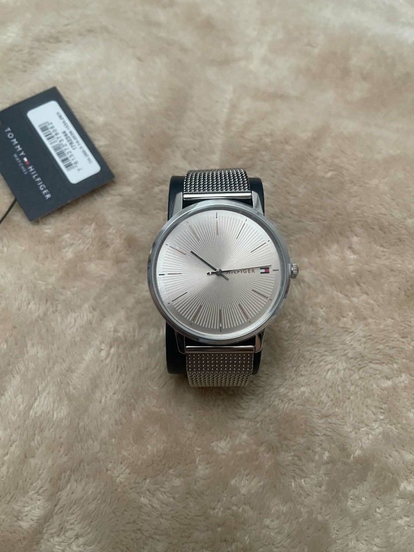 Tommy Hilfiger Silver Mesh Watch 1782244 (Category: Women's Watches) located in Cavite. Submitted by vastowl_7d1ce5 (Listing ID 1470164097, Image 1). Description: - Brand: Tommy Hilfiger - Model: 1782244 - Color: Silver-tone - Dial: Sunburst texture with minimalist markers and logo - Strap: Stainless steel mesh with adjustable clasp - Condition: Clean crystal and polished bezel - Inclusions: Original branded box, tag, and display cushion - Ideal 