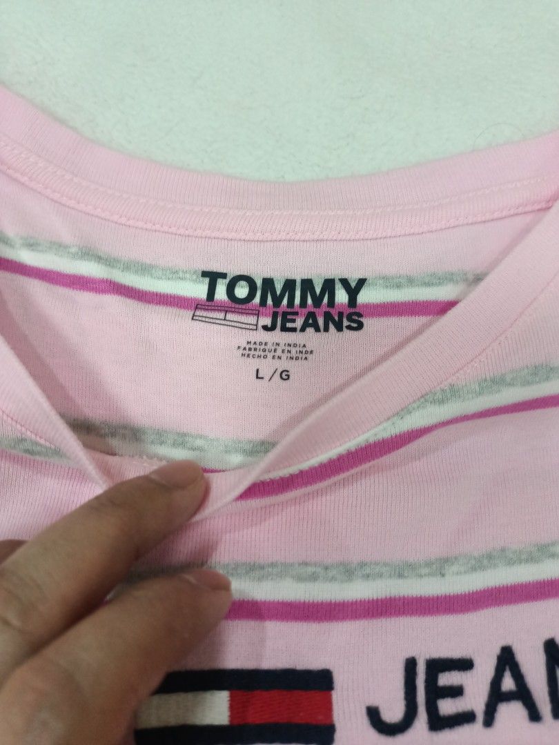 Tommy Jeans Pink Striped Tee Size L (Category: Shirts) located in Manila. Submitted by jollynest24 (Listing ID 1470282475, Image 2). Description: - Brand: Tommy Jeans - Colorway: Pink, white, and grey stripes - Size: L / G - Design: Classic crew neck, short sleeves, and embroidered chest logo - Origin: Made in India - Location : Sampaloc Manila - Gcash ( MOP).