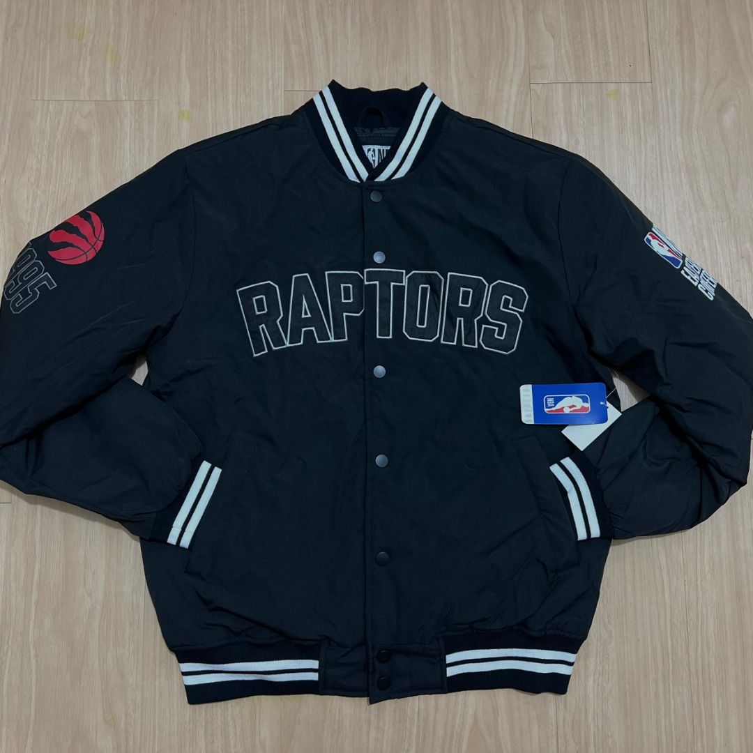 Toronto Raptors NBA Bomber Jacket Black Size S (Category: Coats, Jackets and Outerwear) located in Manila. Submitted by luxurybagsandshoes (Listing ID 1470232231, Image 1). Description: - Item: Brand New Toronto Raptors Varsity Jacket - Size: Small (with original tags attached) - Closure & Trim: Snap-button front with striped collar, cuffs, and hem - Design Details: Embroidered 'RAPTORS' lettering on the chest and a large graphic on the back - Sp
