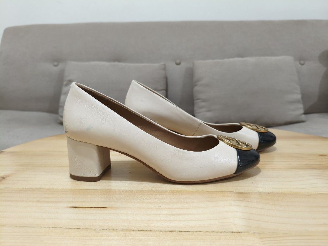 Tory Burch Chelsea Cap-Toe Pumps (Category: Heels) located in Quezon City. Submitted by petie_ph (Listing ID 1470146591, Image 3). Description: - Brand: Tory Burch - Style: Low heel pumps with chunky block heel for comfort - Color/Material: Cream leather upper with black patent cap toe - Original with signs of usage - Retail price ranges from 18K - 19K - Size: 5.5 - Details: Signature gold-tone logo hardware on the front - Interior: Tan leather i