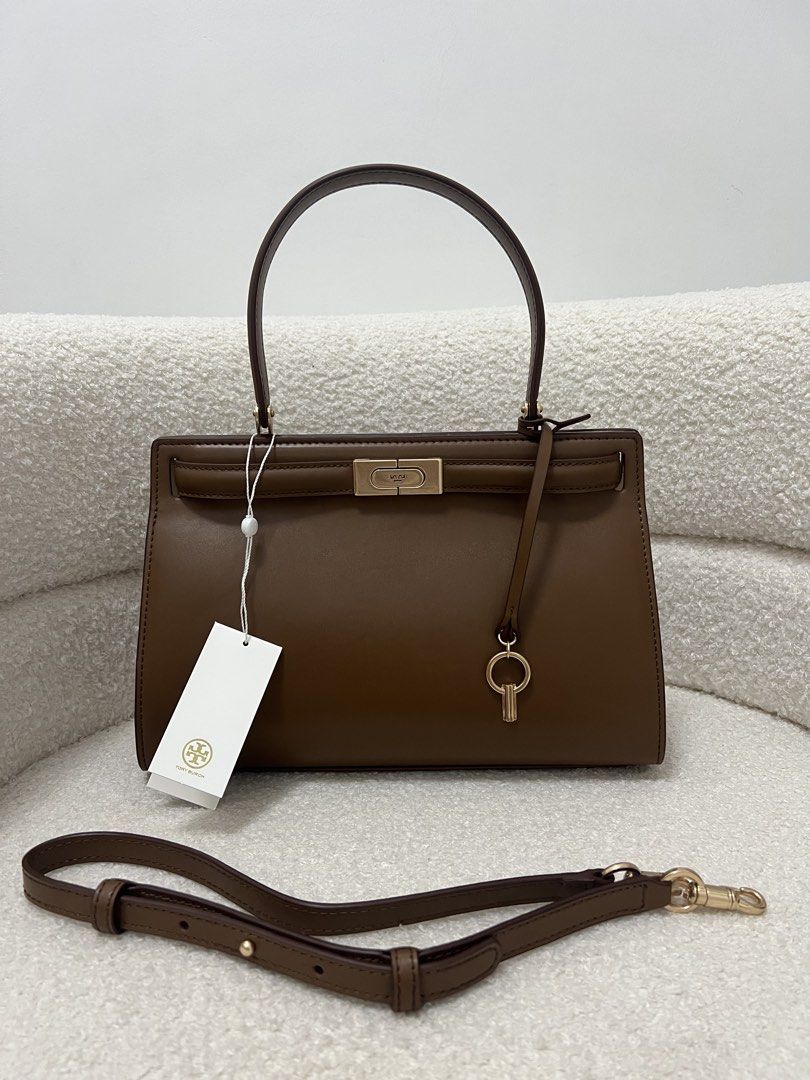 Tory Burch Lee Radziwill Bag (Category: Shoulder Bags) located in Abulug. Submitted by jamiecammie (Listing ID 1470273904, Image 1). Description: - Brand: Tory Burch - Color: Rich brown leather with premium gold hardware - Structure: Structured shape with sturdy top handle and protective bottom studs - Versatility: Includes a detachable shoulder strap for crossbody or hand carry .