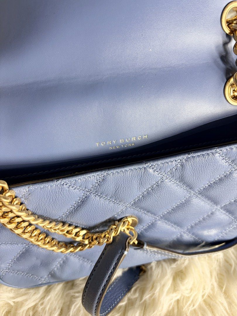 Tory Burch Quilted Leather Convertible Shoulder Bag (Category: Luxury Bags & Wallets) located in Angeles City. Submitted by simplycatchy (Listing ID 1470164351, Image 2). Description: - Brand: Tory Burch - Style: Quilted shoulder bag - Color: Soft periwinkle blue - Material: Premium leather with diamond quilting - Hardware: Gold-tone chain strap with leather guards and iconic Double T logo - Closure: Secure magnetic snap - Compartments: Clean int