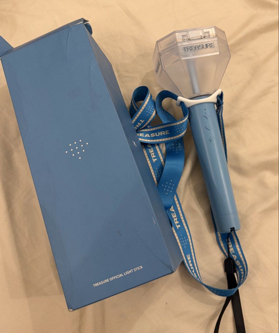 TREASURE Official Light Stick with Box and Strap (Category: Lighting) located in Calamba. Submitted by miss.ksnap (Listing ID 1470324640, Image 1). Description: - Official TREASURE light stick - Tested and fully working for concert season - Includes original light blue box (with minor edge wear) and matching blue strap - Ready to ship out quickly.