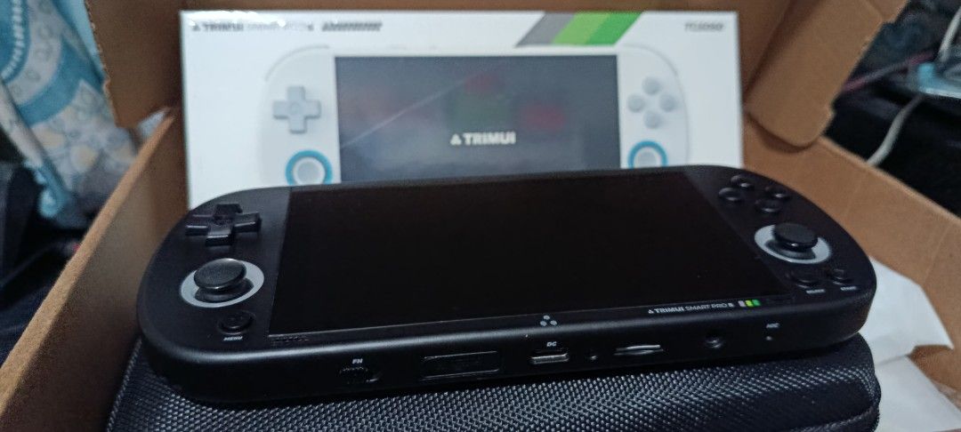 Trimui Smart Pro S Retro Handheld Console (Category: Others) located in Pasig City. Submitted by avatarxero (Listing ID 1470262773, Image 3). Description: - Trimui Smart Pro S handheld console in sleek black - Comes complete with original retail box and protective case - Plays classic retro games from systems like PSP, N64, Dreamcast, etc. on the included original and high quality 64GB microSD card - Features a clear screen with active game short