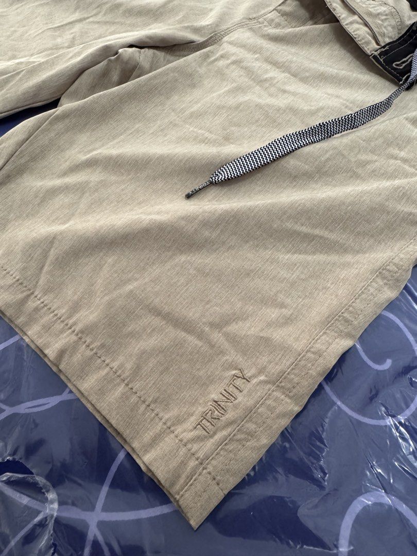 Trinity Hybrid Shorts Size 33 Beige (Pre-loved) (Category: Shorts) located in Santo Tomas. Submitted by toughu (Listing ID 1470145195, Image 3). Description: - Brand/Model: Trinity Hybrid Shorts - Color: Versatile Beige - Size: 33 waist - Material: 92% polyester, 8% spandex for superior flexibility - Features: Drawstring waistband, multiple pockets, and subtle textured look - Ideal for: Workouts, casual days, paddle out, and evening outings.