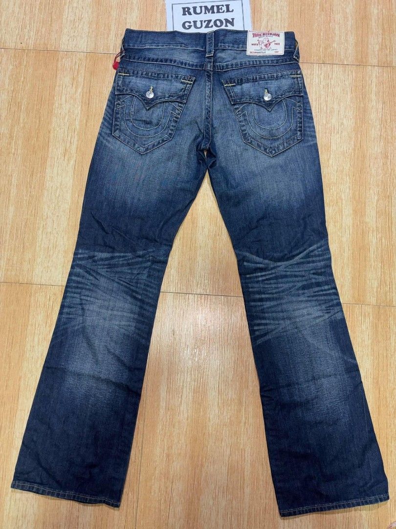 True Religion Bootcut Flap Old Jeans Size 31 (Category: Jeans) located in Quezon City. Submitted by rumel.guzon1630-15361 (Listing ID 1470311136, Image 2). Description: - Brand: True Religion - Style: Bootcut jeans - Size: Waist 31 - Color/Wash: Blue wash with multi-wheat thread accents - Condition: Brand new with original hang tags attached - Details: Distressed front with ripped areas - Pockets: Signature back flap pockets with button closures 