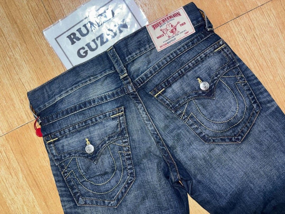 True Religion Bootcut Flap Old Jeans Size 31 (Category: Jeans) located in Quezon City. Submitted by rumel.guzon1630-15361 (Listing ID 1470311136, Image 1). Description: - Brand: True Religion - Style: Bootcut jeans - Size: Waist 31 - Color/Wash: Blue wash with multi-wheat thread accents - Condition: Brand new with original hang tags attached - Details: Distressed front with ripped areas - Pockets: Signature back flap pockets with button closures 