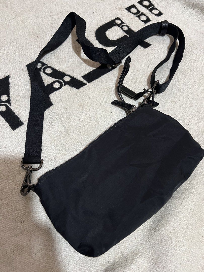 TUMI Black Nylon Crossbody Bag with Adjustable Strap (Category: Cross-body Bags) located in Cagayan de Oro. Submitted by nelsondel21723 (Listing ID 1470230391, Image 3). Description: Tumi black nylon crossbody bag. Compact size, great for daily errands or travel. Includes adjustable black strap and silver-tone hardware. Front features metallic Tumi logo badge. Multiple zipped compartments inside for organization. Clean interior lining. - dimensio