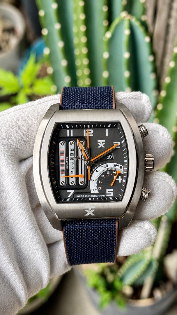 TX Linear Chronograph Watch with Blue Canvas Strap (Category: Men's Watches) located in Manila. Submitted by junjun12356 (Listing ID 1470167997, Image 1). Description: - Brand/Model: TX Linear Chronograph Watch - Dial: Unique vertical minute track with striking orange hands and multiple sub-dials - Case: Brushed stainless steel tonneau case - Strap: Blue textured canvas with comfortable brown leather backing - Condition: good as new .