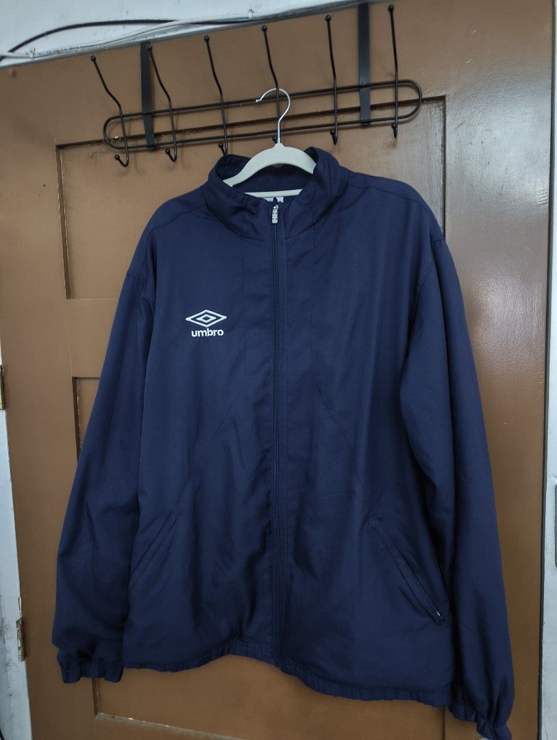 Umbro Vintage Track Jacket (Category: Coats, Jackets and Outerwear) located in San Pedro. Submitted by madvillainkicks (Listing ID 1470152333, Image 1). Description: 25 x 28 supreme umbro alternative Navy blue Umbro track jacket. Full zip front, high collar. White embroidered diamond logo on the chest. Classic retro piece, tailored by in England tag on the inside collar. Mesh inner lining. Ribbed cuffs and hem. Clean look, easy layering piece..