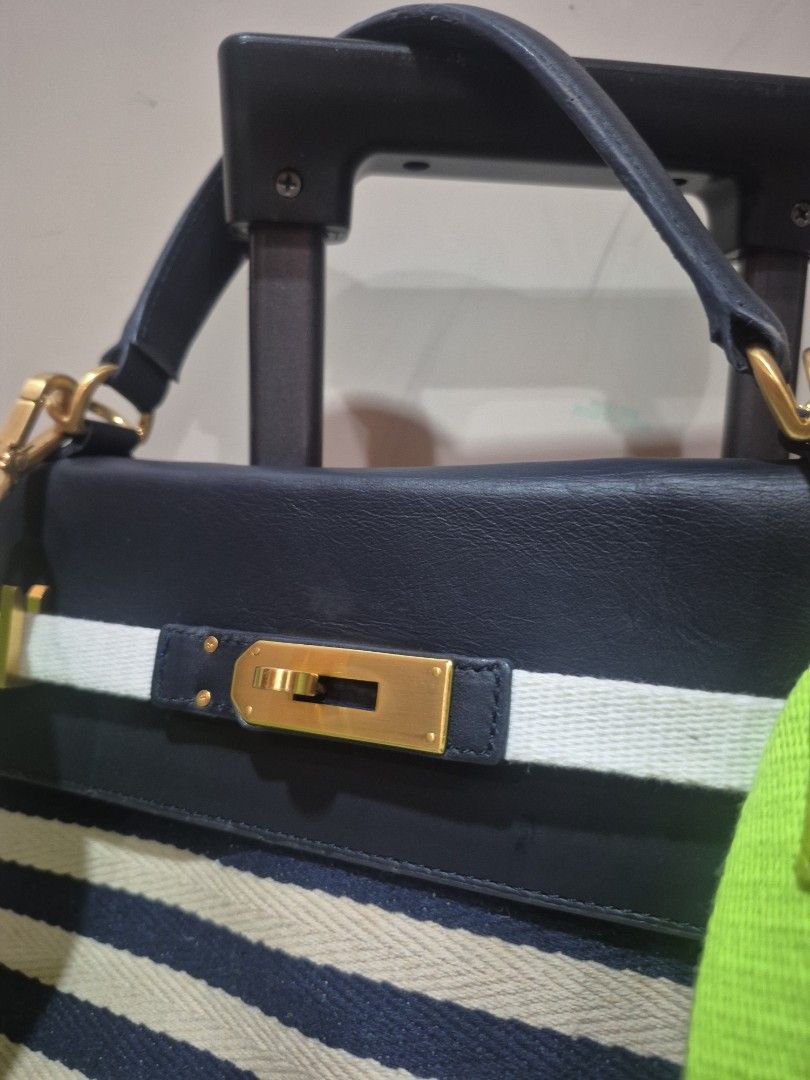 Under 82 Blue and White Striped Handbag with Neon Strap (Category: Tote Bags) located in Iloilo. Submitted by gorgeoustatz (Listing ID 1470278565, Image 3). Description: -GOOD AS NEW!!! Navy blue and cream striped canvas with dark blue leather trim - Elegant gold-tone hardware closure on front flap - Dual dark blue top handles for hand carry - Includes a trendy, bright neon green adjustable crossbody strap - Roomy everyday tote design, perfect fo