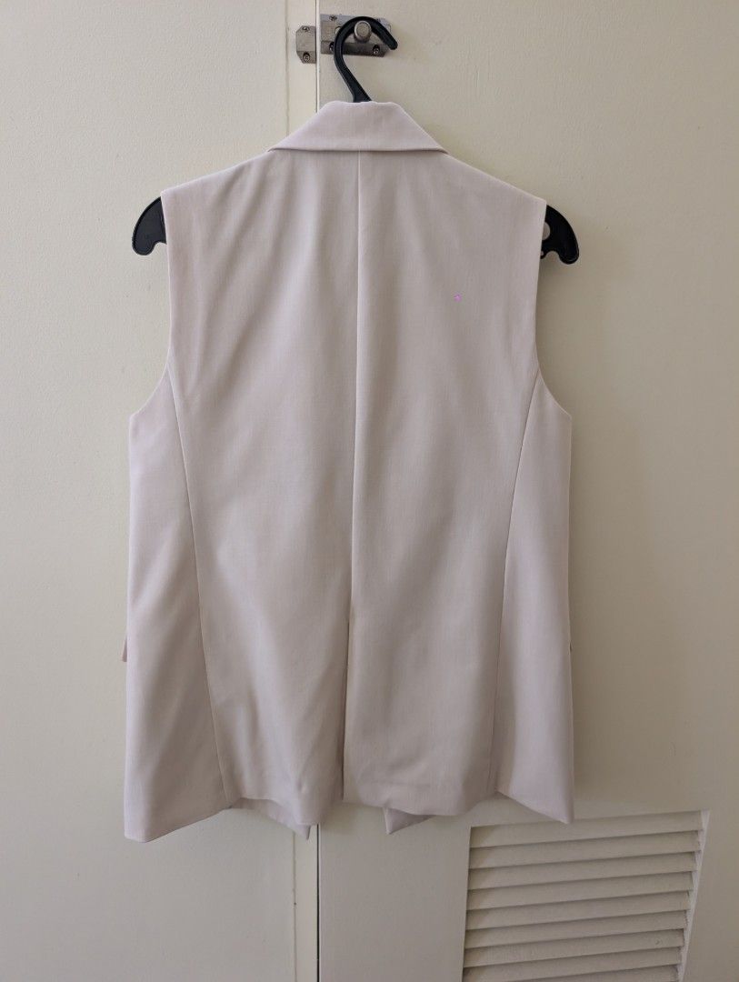 Uniqlo Beige Tailored Vest Size S (Category: Sleeveless) located in Paranaque City. Submitted by clothingarchives (Listing ID 1470195859, Image 2). Description: - Brand: Uniqlo - Color: Classic Beige - Size: S (Fits bust 77-83cm) - Style: Sleeveless tailored blazer vest with lapel collar - Closure: Double-button front - Pockets: Two functional front flap pockets - Details: Clean back with subtle center vent, lightweight inner lining - Material: P