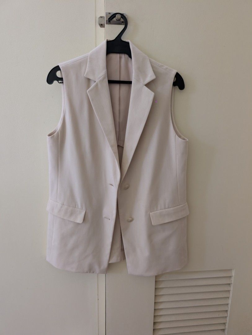 Uniqlo Beige Tailored Vest Size S (Category: Sleeveless) located in Paranaque City. Submitted by clothingarchives (Listing ID 1470195859, Image 1). Description: - Brand: Uniqlo - Color: Classic Beige - Size: S (Fits bust 77-83cm) - Style: Sleeveless tailored blazer vest with lapel collar - Closure: Double-button front - Pockets: Two functional front flap pockets - Details: Clean back with subtle center vent, lightweight inner lining - Material: P