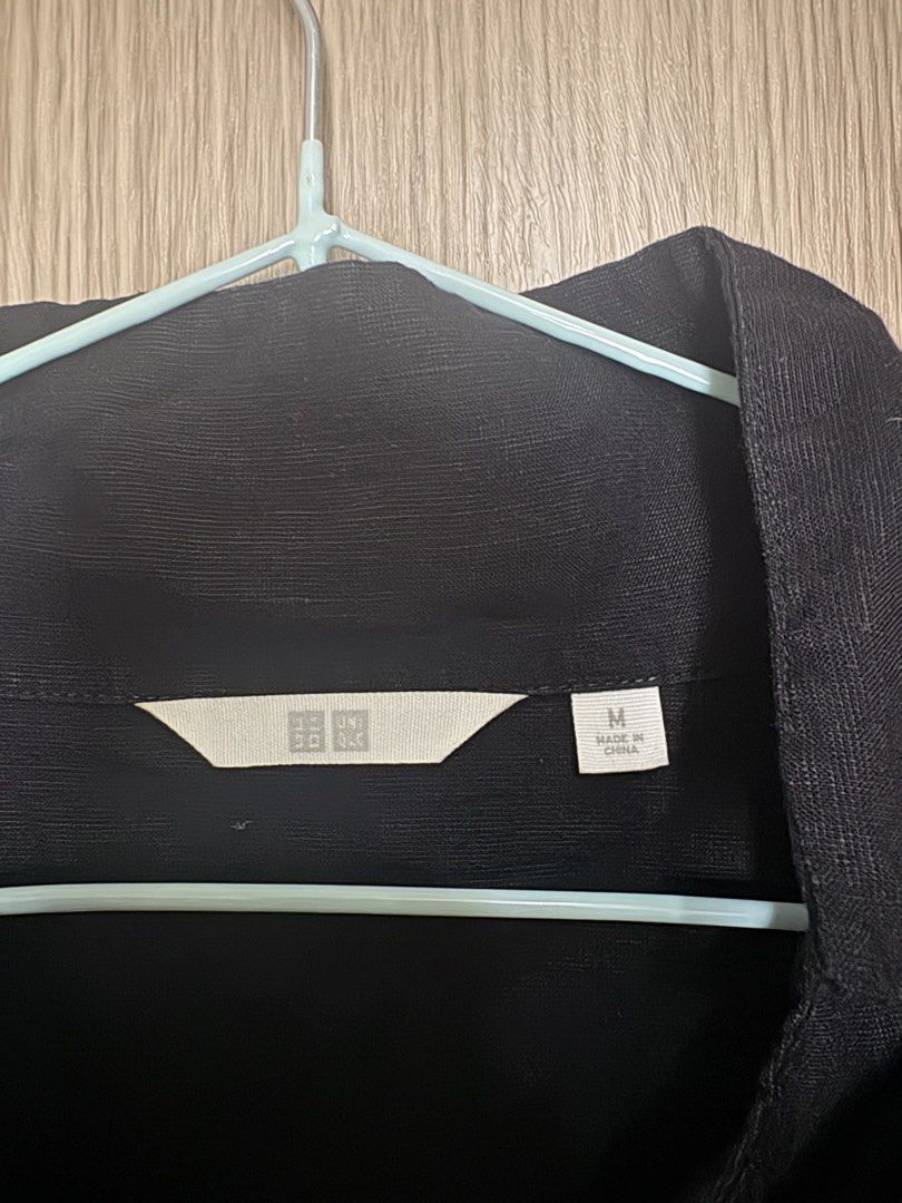 Uniqlo Black Short Sleeve Button Shirt (Category: Shirts) located in Pasay City. Submitted by curatedclearout (Listing ID 1470177876, Image 3). Description: - Brand: Uniqlo - Item: Short sleeve button-down shirt - Size: M (Made in China) - Color: Black (Dark colorway) - Fit & Details: Relaxed fit, collar design, slightly textured fabric - Versatility: Easy to match with pants or shorts, perfect for everyday casual wear.
