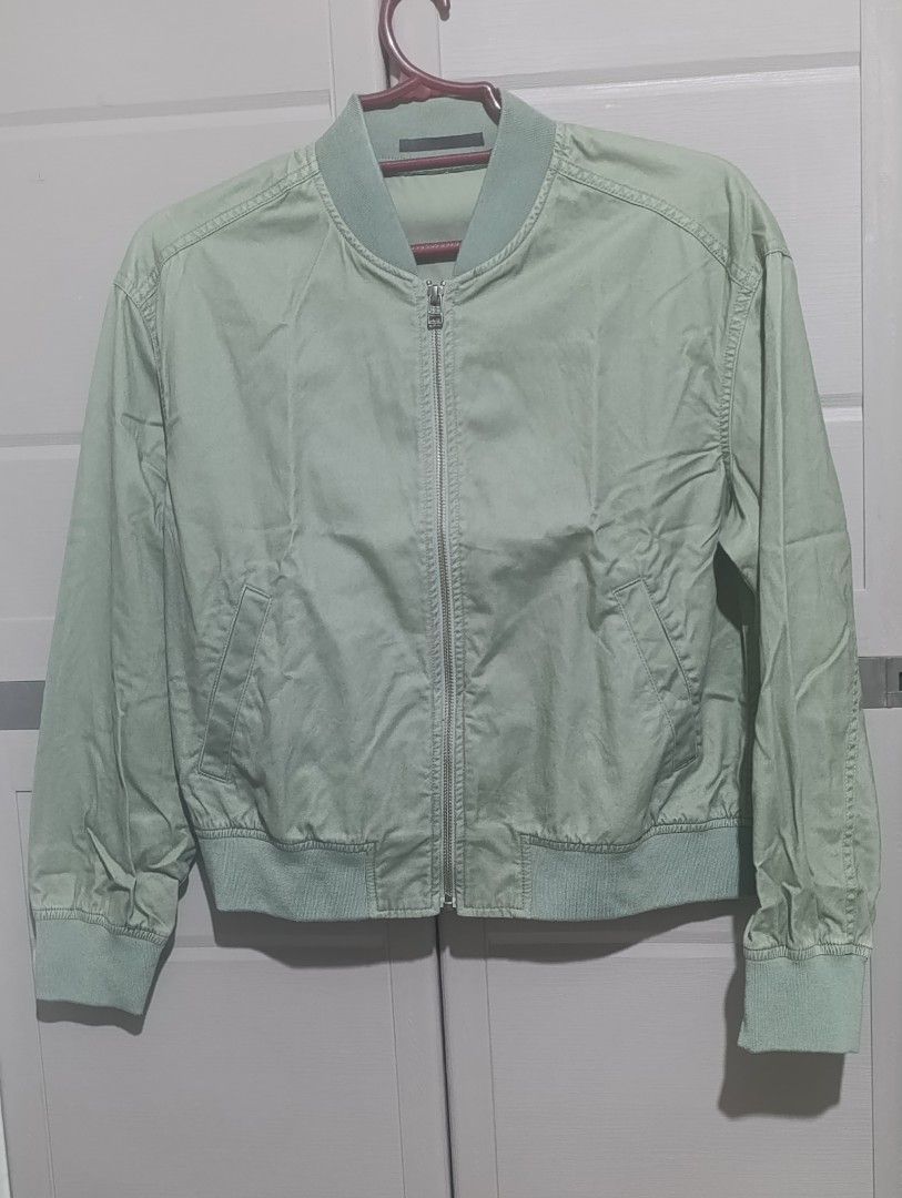 Uniqlo Sage Green Bomber Jacket Size M (Category: Coats, Jackets and Outerwear) located in Manila. Submitted by avicmbe (Listing ID 1470166279, Image 1). Description: - Brand/Model: Uniqlo bomber jacket - Color: Sage green - Size: Medium (standard fit) - Material: Comfortable cotton, polyester, and spandex blend - Features: Zip-up front, side pockets, ribbed collar, cuffs, and hem - Condition: Lightweight, clean inside and out, ready to wear.