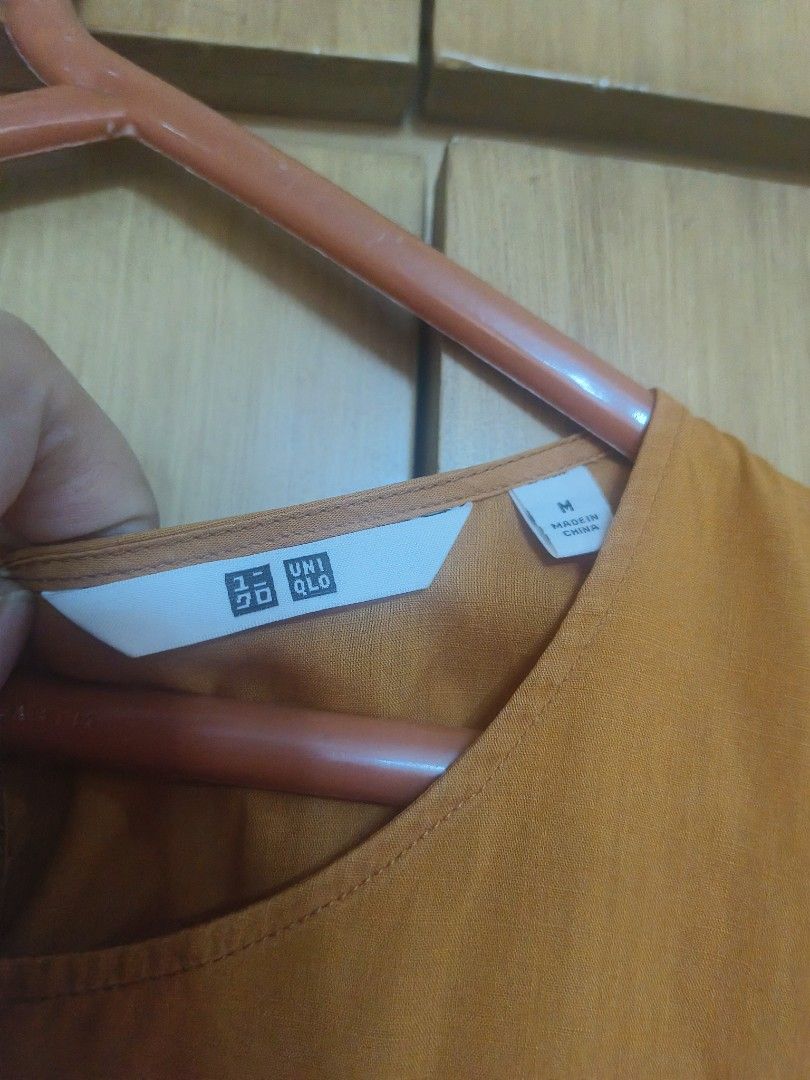 Uniqlo sleeveless (Category: Sleeveless) located in Quezon City. Submitted by majasaw88 (Listing ID 1470217682, Image 2). Description: - Brand: Uniqlo - Size: M - Color: Mustard yellow - Material: Lightweight cotton-linen feel (Made in China) - Design: Cute floral embroidery on the chest, flattering peplum flared hem - Closure: Round neckline with back button closure - Condition: Great for warm weather or layering under cardigans.