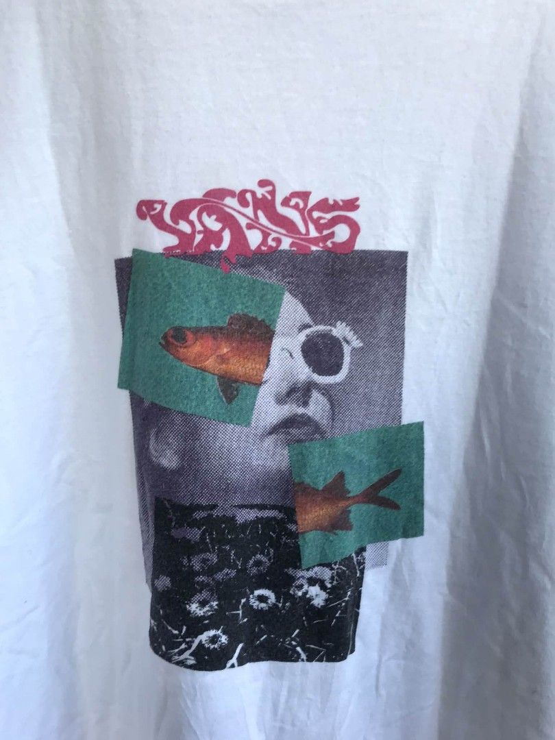 Vans Classic Fit Graphic Tee White Size L (Category: Tshirts & Polo Shirts ) located in Camiling. Submitted by akosiano (Listing ID 1470156886, Image 2). Description: - Brand: Vans - Size: Large - Color: White - Material: 100% Cotton (Made in Mexico) - Design: Front collage graphic with face and fish elements, plus sleeve logo tag - Fit/Style: Classic fit, crew neck, short sleeves - Condition: Excellent, comfortable everyday tee.