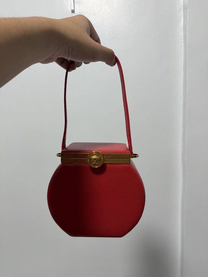 Versace Tribute Vanity Case Bag in Red (Category: Luxury Bags & Wallets) located in Iloilo. Submitted by lorenzoivan (Listing ID 1470266608, Image 3). Description: RARE ‼️ Versace Tribute Vanity Case Bag in Red -₱40,000 LEGIT / AUTHENTIC: Full Inclusion Like New Flaws: dirty dustbag side of handle is a bit out of shape Asking for ₱40,000 (NEGOTIABLE) DM for more inquiries and more pics.