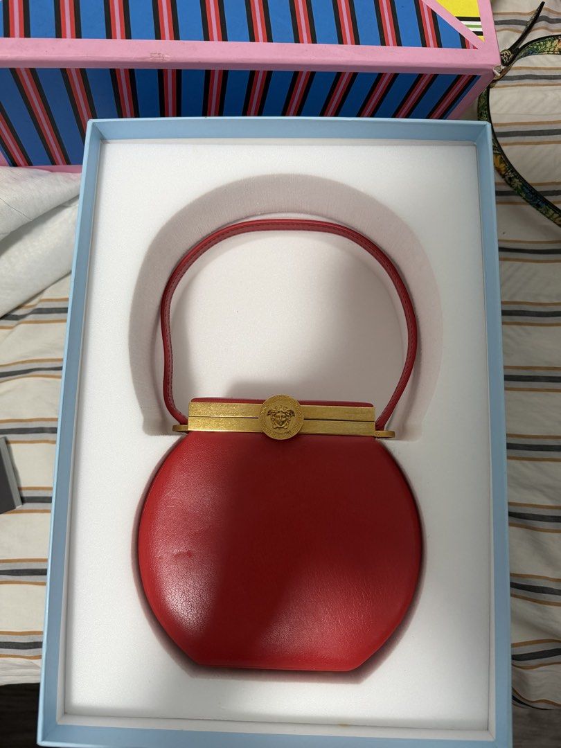 Versace Tribute Vanity Case Bag in Red (Category: Luxury Bags & Wallets) located in Iloilo. Submitted by lorenzoivan (Listing ID 1470266608, Image 2). Description: RARE ‼️ Versace Tribute Vanity Case Bag in Red -₱40,000 LEGIT / AUTHENTIC: Full Inclusion Like New Flaws: dirty dustbag side of handle is a bit out of shape Asking for ₱40,000 (NEGOTIABLE) DM for more inquiries and more pics.