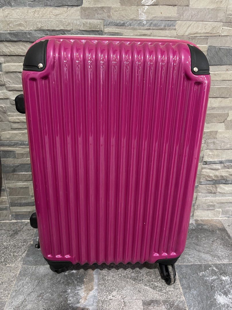 vibrant pink, vertical-ribbed hard-shell rolling suitcase 21x13x9 (Category: Luggage) located in San Fernando. Submitted by japansurpluselyu (Listing ID 1470279487, Image 1). Description: .