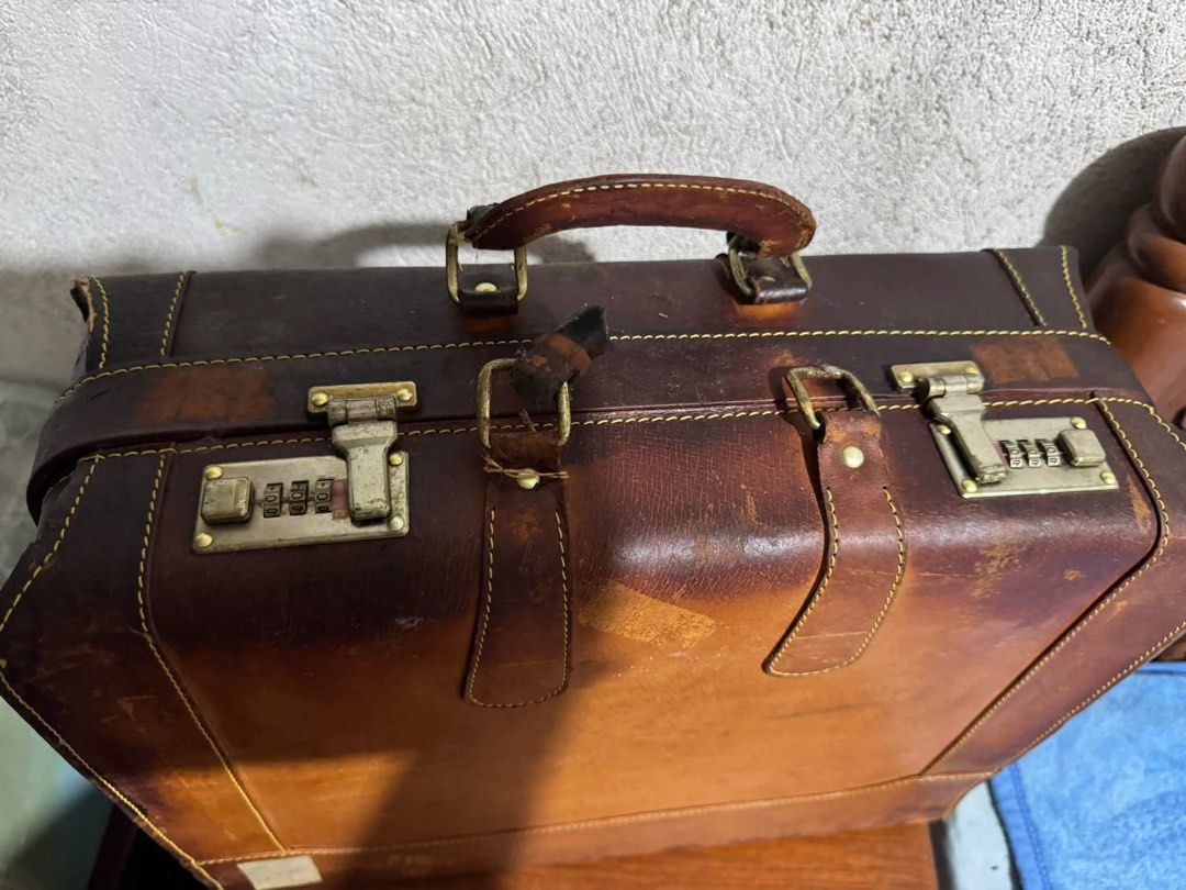 Vintage 1960s Brown Leather Attaché Pilot Briefcase (Category: Briefcases) located in Cainta. Submitted by elainelawenko (Listing ID 1470263056, Image 2). Description: - Vintage brown leather attaché and pilot briefcase - Genuine cowhide leather construction with brown fabric-lined interior - Dimensions: 18x6x14 inches - Features brass combination locks, top carrying handle, and organized internal compartments with straps - Condition note: Shows 