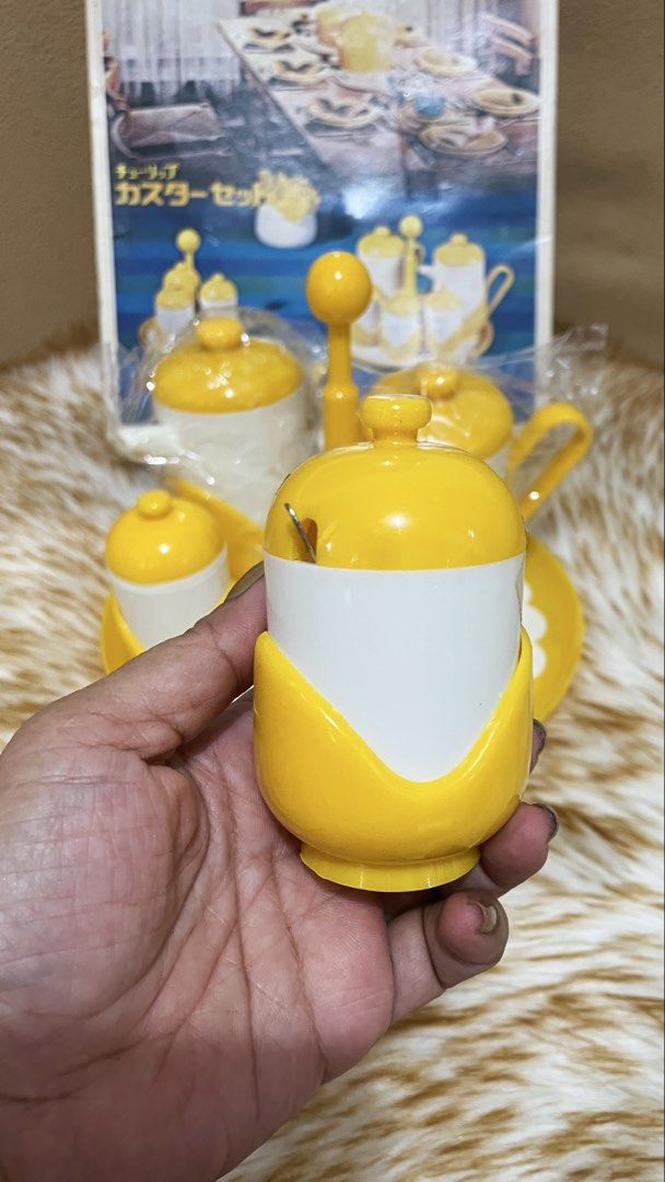 vintage 1970s Sansei Plastic Tulip Caster Set (Category: Vintage Collectibles) located in Quezon City. Submitted by sissymissy1527 (Listing ID 1470320925, Image 3). Description: This is a set of cute tulip-shaped spice containers and a stand. This is a 6-piece set including a soy sauce dispenser, a sauce dispenser, salt and pepper dispensers, a mustard dispenser, and a stand. Size Stand diameter: approx. 22 cm, height: approx. 18 cm.
