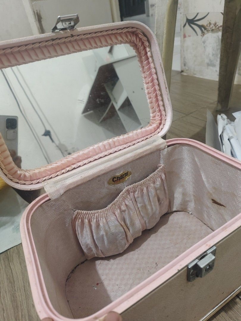 Vintage Charm Pink Makeup Vanity Case Train Case (Category: Purses & Pouches) located in Bulacan. Submitted by babz30261 (Listing ID 1470275566, Image 2). Description: - Style: Vintage pink textured makeup case - Features: Built-in mirror, top handle, front pocket, and silver-tone hardware latch - Condition: Exterior has marks and scuffs; interior shows discoloration and staining from age and use - Ideal for: Retro lovers, vanity organization, or