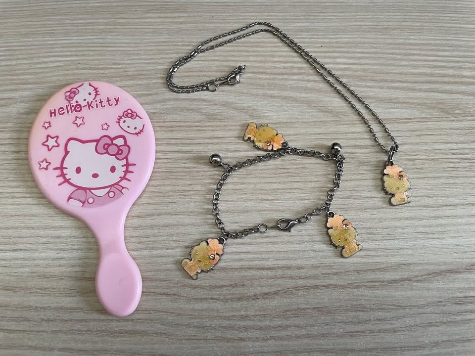 Vintage Hello Kitty Jewelry & Hand Mirror Bundle (Category: Body Jewelry) located in Cebu City. Submitted by s_415 (Listing ID 1470206590, Image 2). Description: ✨ Hello Kitty Bundle ✨ Adorable Sanrio Hello Kitty set featuring a mini pink handheld mirror, a pendant necklace, and a charm bracelet. Included Items: - 1 Handheld Mirror - 1 Charm Necklace - 1 Charm Bracelet Material: Base Metal / Alloy fashion jewelry Color: Silver-tone chains with a 