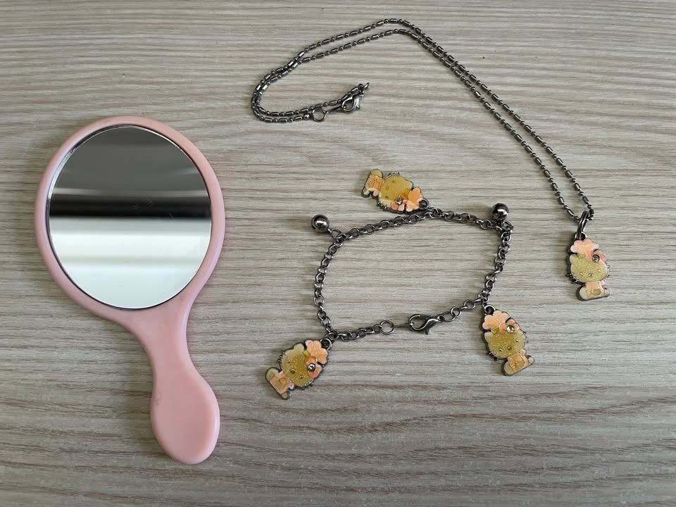 Vintage Hello Kitty Jewelry & Hand Mirror Bundle (Category: Body Jewelry) located in Cebu City. Submitted by s_415 (Listing ID 1470206590, Image 1). Description: ✨ Hello Kitty Bundle ✨ Adorable Sanrio Hello Kitty set featuring a mini pink handheld mirror, a pendant necklace, and a charm bracelet. Included Items: - 1 Handheld Mirror - 1 Charm Necklace - 1 Charm Bracelet Material: Base Metal / Alloy fashion jewelry Color: Silver-tone chains with a 