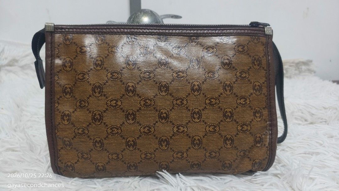 VINTAGE MORABITO PARIS MONOGRAM CLUTCH (Category: Belt bags, Clutches and Pouches) located in Kalibo. Submitted by secondchances.thriftsh8p (Listing ID 1470312950, Image 1). Description: - Brown patterned coated canvas with repeating monogram print - Dark brown leather trim and top zip closure - Convenient attached wrist strap for easy carrying - Compact size ideal for keys, cards, and lipstick - Great everyday or travel accessory.