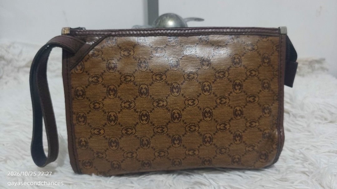 VINTAGE MORABITO PARIS MONOGRAM CLUTCH (Category: Belt bags, Clutches and Pouches) located in Kalibo. Submitted by secondchances.thriftsh8p (Listing ID 1470312950, Image 2). Description: - Brown patterned coated canvas with repeating monogram print - Dark brown leather trim and top zip closure - Convenient attached wrist strap for easy carrying - Compact size ideal for keys, cards, and lipstick - Great everyday or travel accessory.