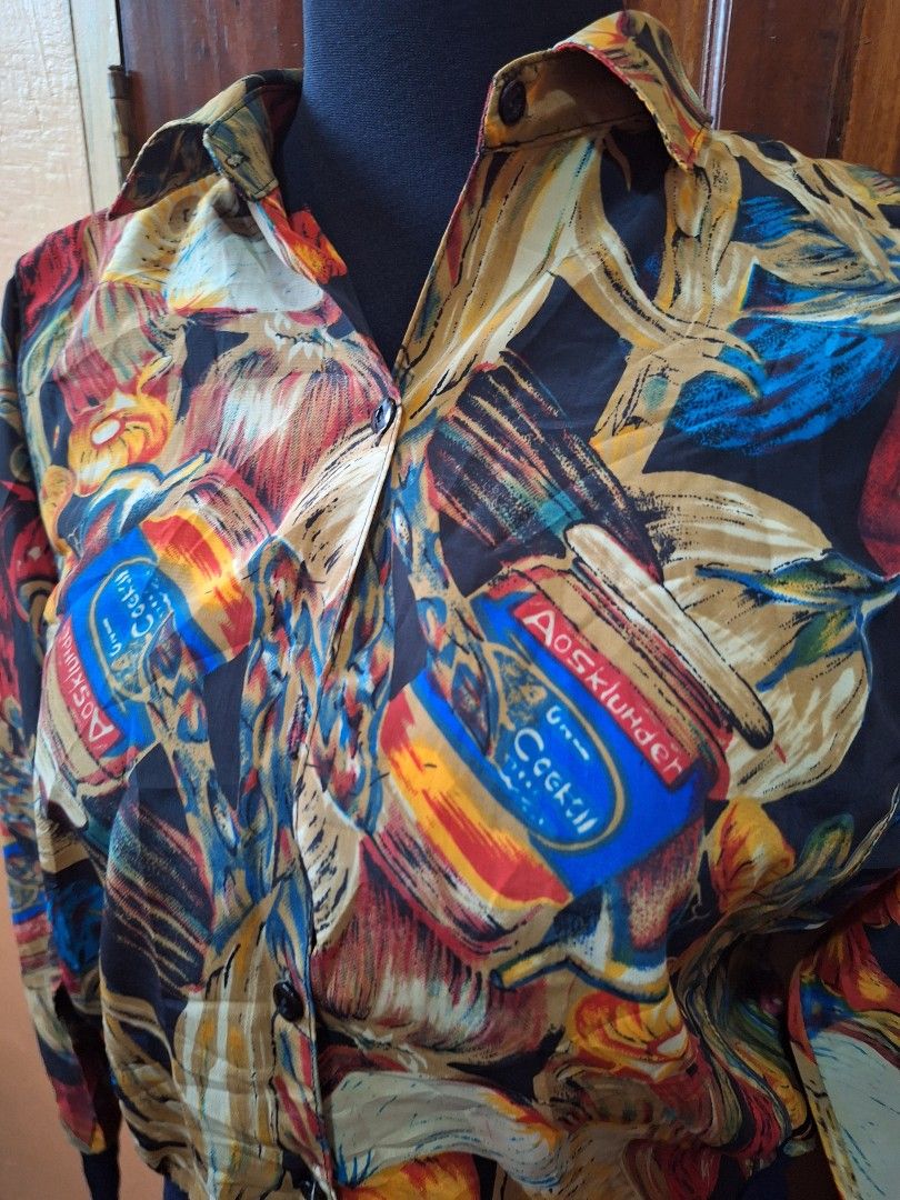 Vintage Multicolour Food Print Bomber Jacket (Category: Coats, Jackets and Outerwear) located in Balamban. Submitted by ubethan (Listing ID 1470213019, Image 3). Description: - Bold all-over print featuring jars of cocktails, vegetables, and fruit - Lightweight and smooth fabric for comfortable wear - Classic collar with a button-up front closure - Dark blue ribbed cuffs and hem for a stylish finish - Eye-catching statement piece to elevate your 