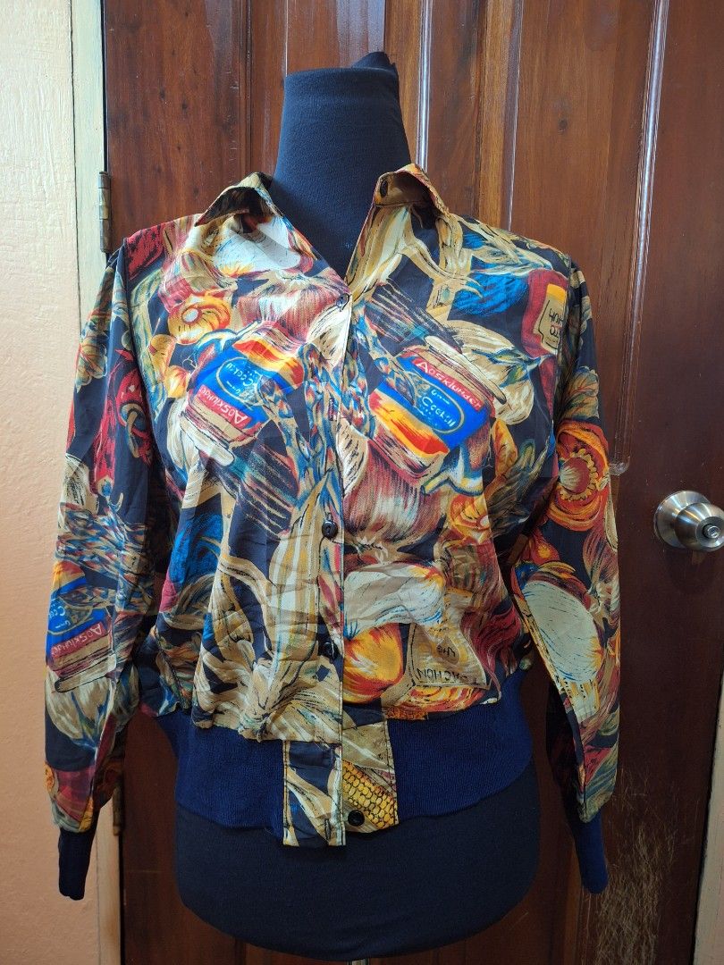 Vintage Multicolour Food Print Bomber Jacket (Category: Coats, Jackets and Outerwear) located in Balamban. Submitted by ubethan (Listing ID 1470213019, Image 1). Description: - Bold all-over print featuring jars of cocktails, vegetables, and fruit - Lightweight and smooth fabric for comfortable wear - Classic collar with a button-up front closure - Dark blue ribbed cuffs and hem for a stylish finish - Eye-catching statement piece to elevate your 