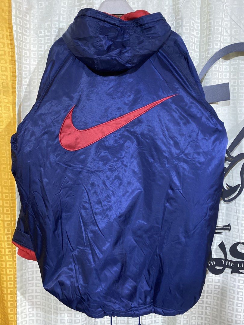 Vintage Nike Blue Red Windbreaker Jacket Size L (Category: Coats, Jackets and Outerwear) located in Caloocan City. Submitted by camarcenin42067 (Listing ID 1470279043, Image 2). Description: - Brand/Model: Nike Blue Windbreaker Jacket - Size: Large - Origin: Made in Vietnam - Color/Design: Blue exterior with a contrasting red quilted inner lining - Features: Snap button closure, drawstring hood, dual front pockets, and red ribbed cuffs - Branding