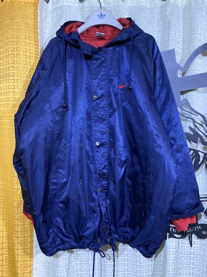 Vintage Nike Blue Red Windbreaker Jacket Size L (Category: Coats, Jackets and Outerwear) located in Caloocan City. Submitted by camarcenin42067 (Listing ID 1470279043, Image 1). Description: - Brand/Model: Nike Blue Windbreaker Jacket - Size: Large - Origin: Made in Vietnam - Color/Design: Blue exterior with a contrasting red quilted inner lining - Features: Snap button closure, drawstring hood, dual front pockets, and red ribbed cuffs - Branding
