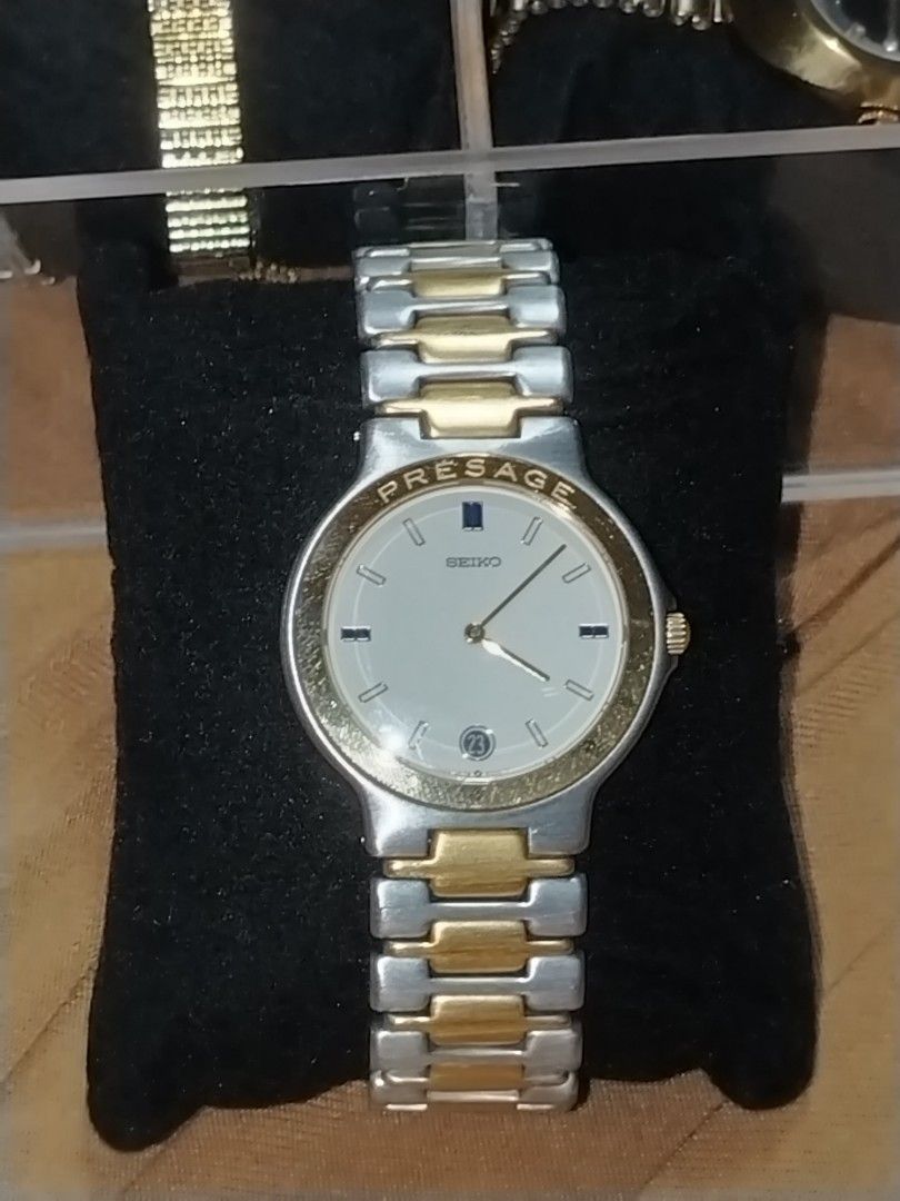 Vintage Seiko Presage Quartz (Category: Luxury Watches) located in Manila. Submitted by chixs_timepiece (Listing ID 1470227698, Image 2). Description: - Brand: Seiko Presage - Movement: Battery-operated quartz - Dial: White dial with date window at the bottom - Design: Two-tone silver and gold bracelet links with branded logo clasp - Case Back: Stainless steel with stamped serial numbers - Condition: Normal wear on case and bracelet from regular 