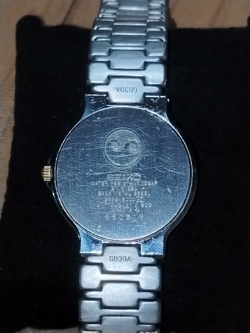 Vintage Seiko Presage Quartz (Category: Luxury Watches) located in Manila. Submitted by chixs_timepiece (Listing ID 1470227698, Image 3). Description: - Brand: Seiko Presage - Movement: Battery-operated quartz - Dial: White dial with date window at the bottom - Design: Two-tone silver and gold bracelet links with branded logo clasp - Case Back: Stainless steel with stamped serial numbers - Condition: Normal wear on case and bracelet from regular 