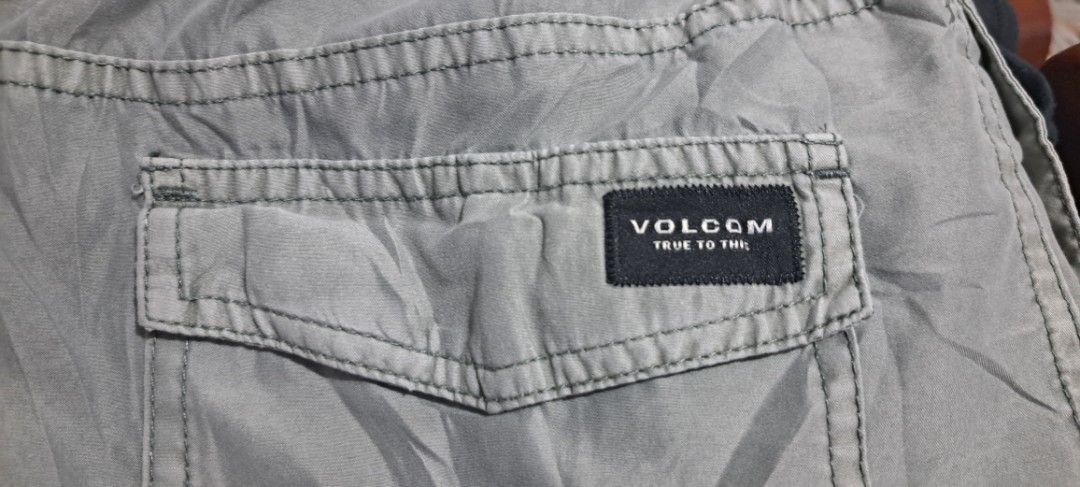 Volcom Grey Boardshorts Size S (Category: Swim Trunks & Board Shorts) located in San Fernando, Camarines Sur. Submitted by ladderaya (Listing ID 1470241116, Image 3). Description: - Brand/Model: Volcom grey shorts - Size: S - Waistband: Elastic with adjustable drawstring - Pockets: Convenient side pockets and one back pocket with Volcom True To This label - Details: Round Volcom logo patch near the bottom hem - Material: Lightweight fabric, ideal