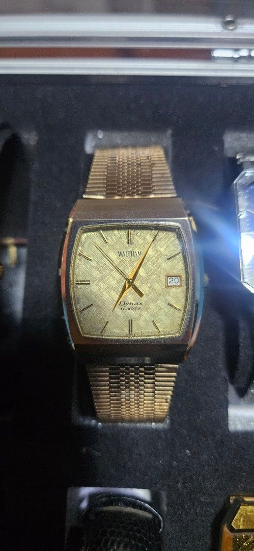 Waltham Dynax Quartz Gold Tone Watch (Category: Women's Watches) located in Santa Maria. Submitted by rommelmateo (Listing ID 1470215848, Image 1). Description: - Brand: Waltham Dynax - Movement: Quartz (battery-powered) - Color/Finish: Gold tone - Dial: Textured warm metallic shade with a date window near the top right - Strap: Matching integrated mesh strap with a geometric link pattern - Case: Classic square shape with rounded corners - Condit